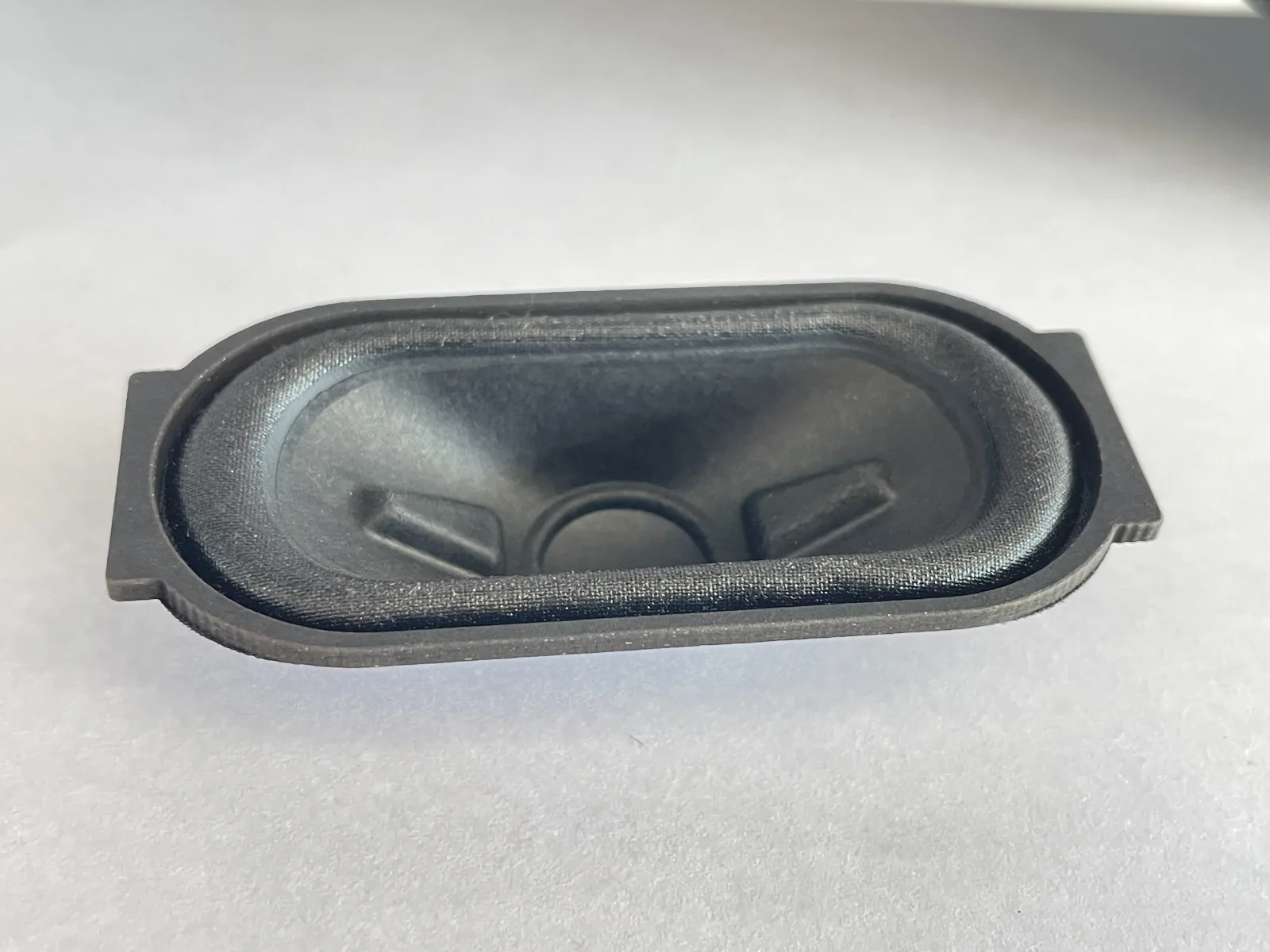 Close view of an oval passive-radiator diaphragm